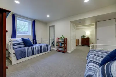 a bedroom with two beds and a window at Cozy Brookville Home with Fire Pit and Deck! in Brookville