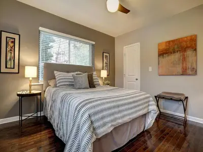 a bedroom with a bed and two lamps and a window at Bright 2BR near downtown in Cincinnati
