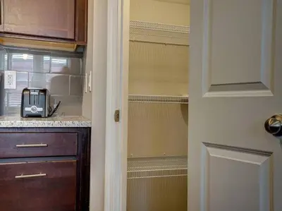a kitchen with a closet with a toaster in it at Bright 2BR near downtown in Cincinnati