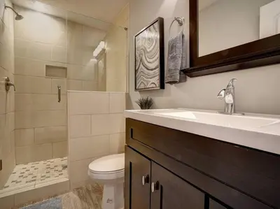 a bathroom with a sink and a toilet and a shower at Bright 2BR near downtown in Cincinnati