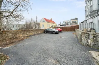 a car parked in a parking lot next to a wall at Stylish Mt Adams 1BR in great location in Cincinnati
