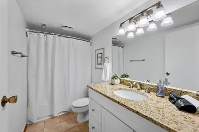 a bathroom with a sink and a toilet and a shower at Stylish Mt Adams 1BR in great location in Cincinnati