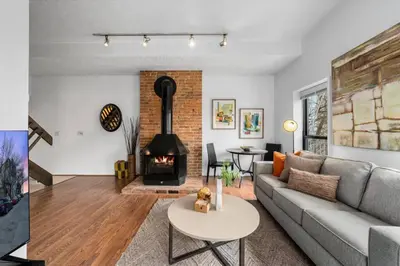 a living room with a couch and a fireplace at Stylish Mt Adams 1BR in great location in Cincinnati