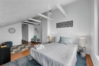 a white bedroom with a large bed in a room at Stylish Mt Adams 1BR in great location in Cincinnati