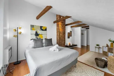 a bedroom with a large white bed in a room at Charming Mt Adams 1BR in Prime Location in Cincinnati