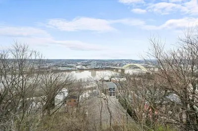 a view of a river with a bridge in the background at Charming Mt Adams 1BR in Prime Location in Cincinnati