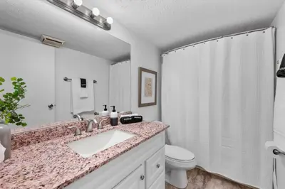 a bathroom with a sink and a toilet and a shower at Charming Mt Adams 1BR in Prime Location in Cincinnati