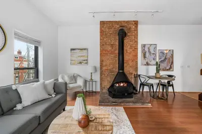 a living room with a couch and a fireplace at Charming Mt Adams 1BR in Prime Location in Cincinnati