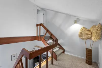a room with a staircase with a light and a lamp at Charming Mt Adams 1BR in Prime Location in Cincinnati