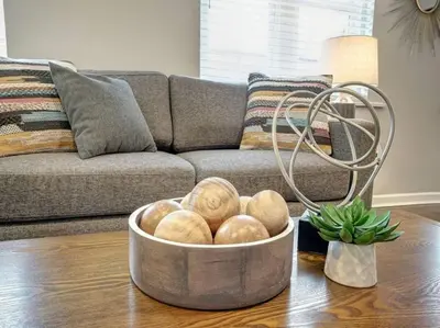 a bowl of bread on a table in a living room at Two Comfy Condos Near City Center OTR UC Zoo in Cincinnati