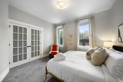a bedroom with a large white bed and a window at Walkable 2BR near Findlay Market Downtown UC in Cincinnati