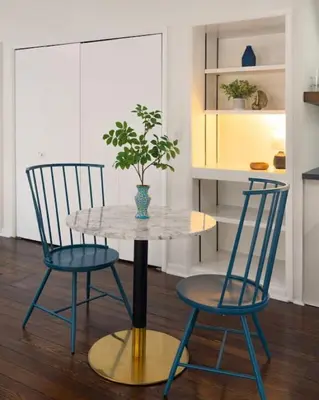 a table with two chairs and a potted plant on it at Spacious Studio Central Locale in Cincinnati