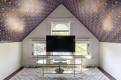 a living room with a tv and a table at Spacious Studio Central Locale in Cincinnati