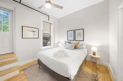 a white bedroom with a large bed and a window at Huge Retrea w Rooftop Deck Stay At Farmers Market in Cincinnati