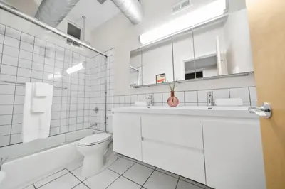 a white bathroom with a toilet and a sink at Huge Retrea w Rooftop Deck Stay At Farmers Market in Cincinnati