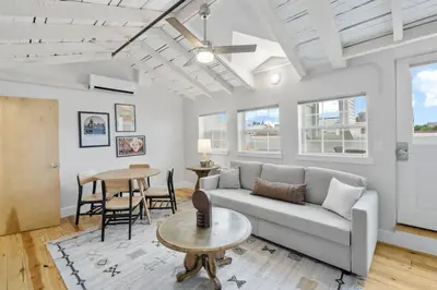 a living room with a couch and a table at Huge Retrea w Rooftop Deck Stay At Farmers Market in Cincinnati