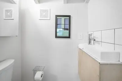 a white bathroom with a sink and a toilet at Huge Retrea w Rooftop Deck Stay At Farmers Market in Cincinnati