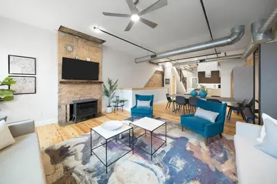 a living room with a couch and a table at Huge Retrea w Rooftop Deck Stay At Farmers Market in Cincinnati