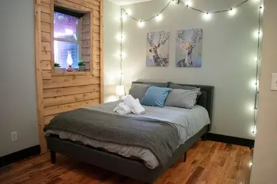 a bedroom with a bed with lights on it at Great Parkside Microapartment Location AND Price in Cincinnati