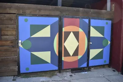 a pair of doors with a colorful painting on them at Great Parkside Microapartment Location AND Price in Cincinnati