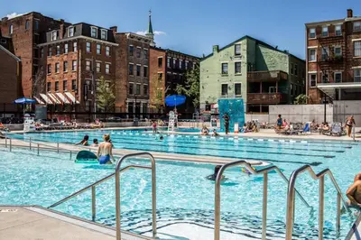 a large swimming pool with people in the water at Great Parkside Microapartment Location AND Price in Cincinnati