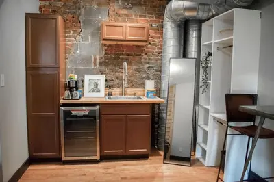 a kitchen with a sink and a refrigerator at Great Parkside Microapartment Location AND Price in Cincinnati