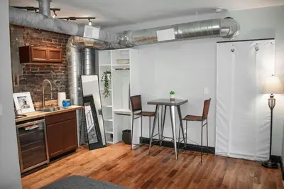 a kitchen with a table and chairs in a room at Great Parkside Microapartment Location AND Price in Cincinnati