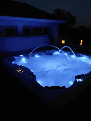 a hot tub with lights in the dark at 4BR Home - Pets Allowed by ARK Experience in Williamstown