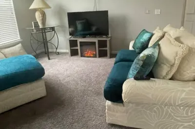 a living room with a couch and a fireplace at Stylish and Spacious, close to the Hospital. in Fort Wayne