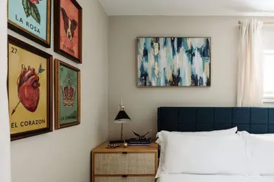 a bedroom with a bed and some pictures on the wall at NEWLY Listed! Westlake Stylish in Westlake