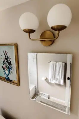 a bathroom with a mirror and a lamp and towels at NEWLY Listed! Westlake Stylish in Westlake