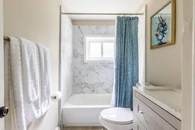 a bathroom with a tub and a toilet and a shower at NEWLY Listed! Westlake Stylish in Westlake