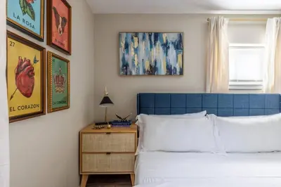 a bedroom with a blue headboard and a bed with a night stand at NEWLY Listed! Westlake Stylish in Westlake