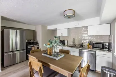 a kitchen with a wooden table with chairs in it at NEWLY Listed! Westlake Stylish in Westlake