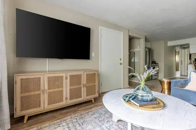a living room with a large flat screen tv on a wall at NEWLY Listed! Westlake Stylish in Westlake