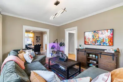 a living room with a couch and a flat screen tv at Modern Oakley Retreat - King Bed - Free Parking - Centrally Located in Cincinnati
