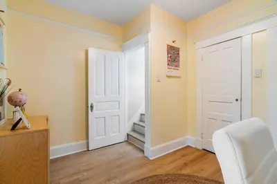 a room with a white door and a white chair at Modern Oakley Retreat - King Bed - Free Parking - Centrally Located in Cincinnati