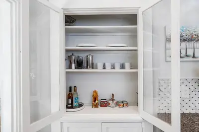 a white pantry with bottles and drinks in it at Modern Oakley Retreat - King Bed - Free Parking - Centrally Located in Cincinnati