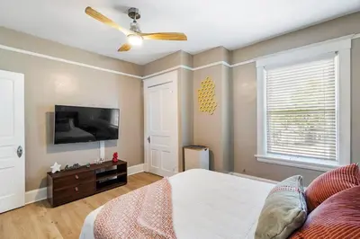 a bedroom with a bed and a flat screen tv at Modern Oakley Retreat - King Bed - Free Parking - Centrally Located in Cincinnati
