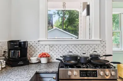 a kitchen with a stove with pots and pans on it at Modern Oakley Retreat - King Bed - Free Parking - Centrally Located in Cincinnati