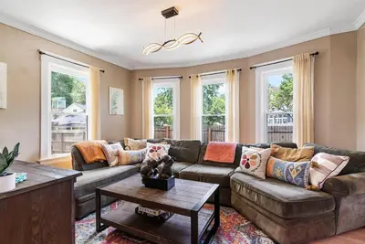a living room with a couch and a table at Modern Oakley Retreat - King Bed - Free Parking - Centrally Located in Cincinnati