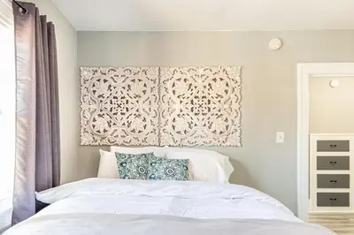 a bedroom with a bed with a wall art above it at The 1920’s Dutch Colonial - Highland Square in Akron