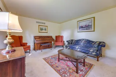 a living room with a couch and a table and a piano at Family-Friendly West Chester Twp Home with Pool! in West Chester