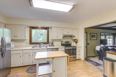 a kitchen with white cabinets and a stainless steel refrigerator at Family-Friendly West Chester Twp Home with Pool! in West Chester