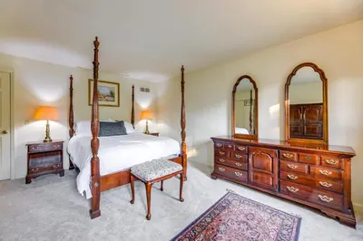 a bedroom with a bed and a dresser and mirrors at Family-Friendly West Chester Twp Home with Pool! in West Chester