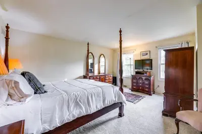 a bedroom with a bed and a flat screen tv at Family-Friendly West Chester Twp Home with Pool! in West Chester