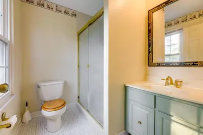 a bathroom with a toilet and a sink and a mirror at Family-Friendly West Chester Twp Home with Pool! in West Chester