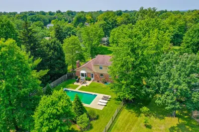 an aerial view of a house with a swimming pool at Family-Friendly West Chester Twp Home with Pool! in West Chester