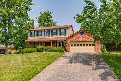 a large brick house with a driveway at Family-Friendly West Chester Twp Home with Pool! in West Chester