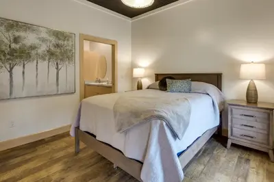 a bedroom with a bed and a painting on the wall at Downtown Millersburg Retreat with Sleek Interior! in Millersburg